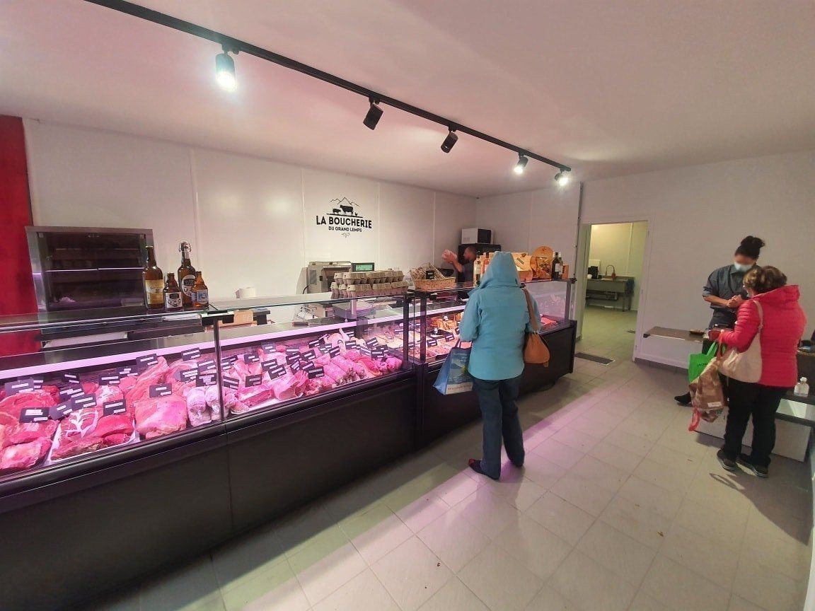 Clientes devant les vitrines réfrigérées de la boucherie-charcuterie du Grand Lemps